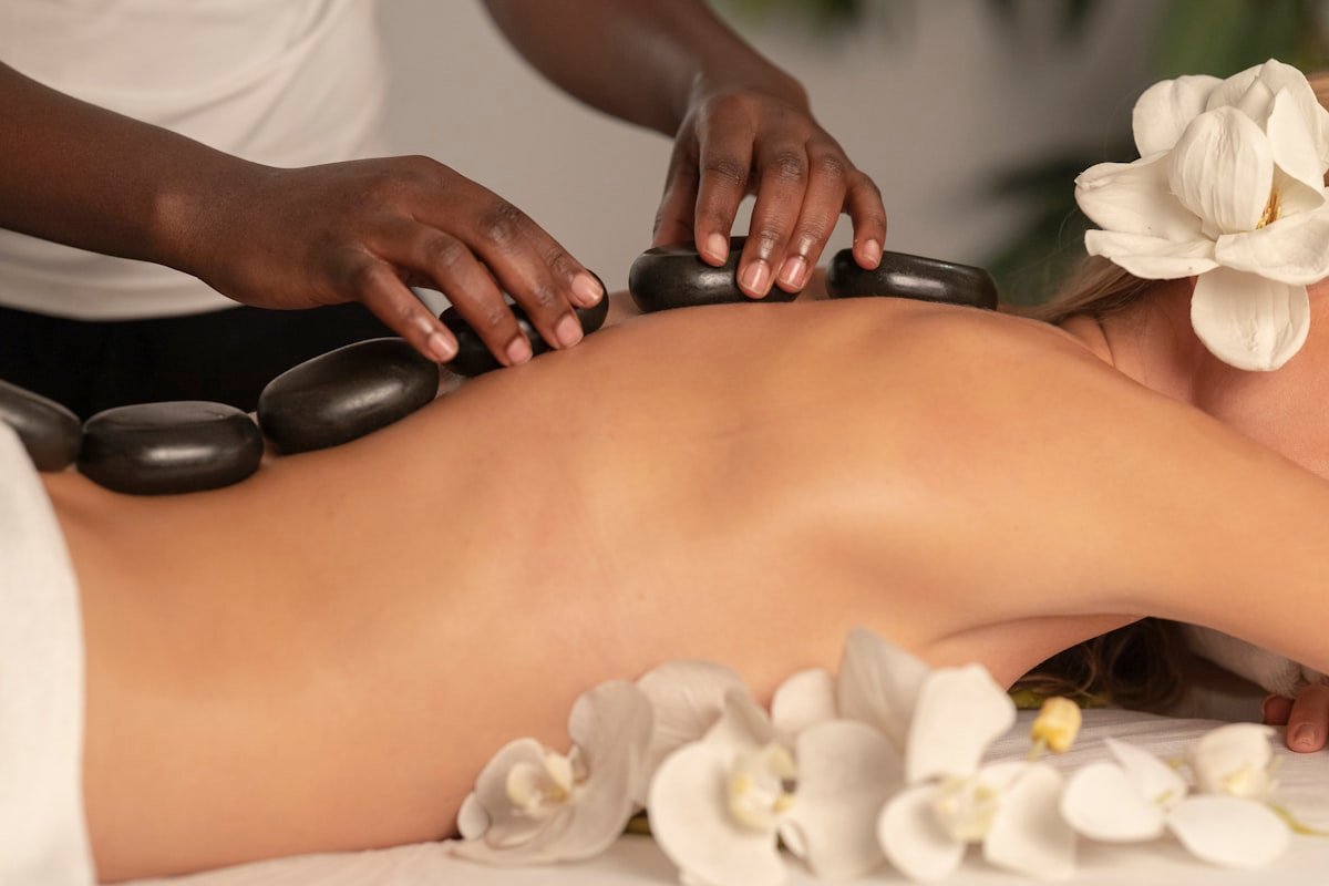 Ayurvedic hot-stone therapy with white flowers